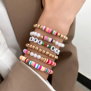 Detail shot of multi-layer colorful clay Heishi bead bracelets with LOVE letter beads