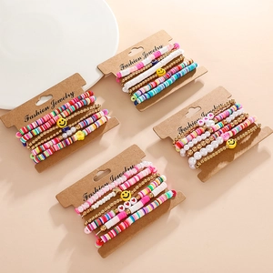 Detail of colorful Heishi clay bead bracelets with LOVE letters and smiley faces on card