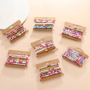 Close-up of colorful polymer clay heishi beads and gold charms on carded bracelets