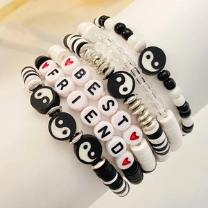 Detail of beaded bracelets set featuring Best Friends letters and yin yang symbols