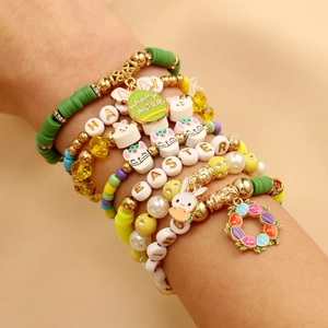 Detail of colorful Easter clay bead bracelet with Happy Easter bunny charm and gold beads