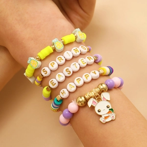 Detail of beaded Easter bracelets with colorful clay disks, letters, and bunny pendant