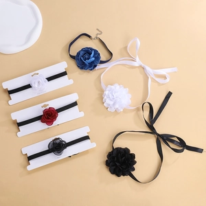 Detailed flat lay of velvet and chiffon rose chokers in multiple colors and textures