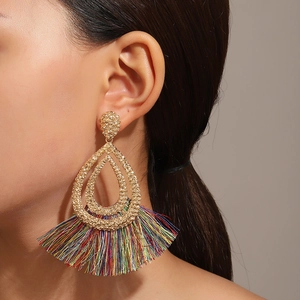 Bohemian hollow water drop gold earrings with colorful fringe tassels on model