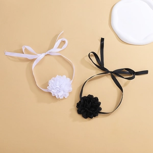 Detailed close-up of handmade fabric rose chokers in black and white ribbon styles