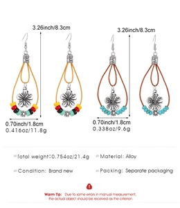 Detail view of Bohemian tassel earrings showing size 8.3cm and alloy flower charm