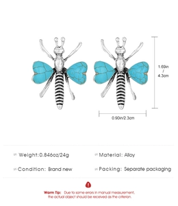 Detailed view of silver dragonfly earrings with turquoise wings and size measurements