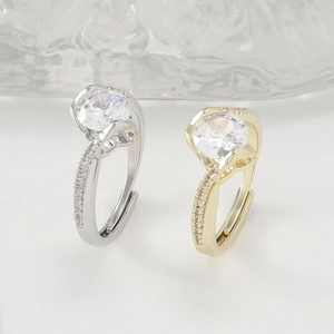 Detailed view of silver and gold adjustable rings with round cut diamond and pink side stones