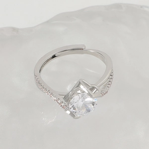 Detailed macro of silver open ring with round clear zircon and pink side stones
