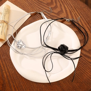 Detail of silver and black rose choker necklaces with adjustable long cord ties