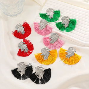 Flat lay of retro fan-shaped tassel earrings in vibrant red, pink, yellow, and green colors