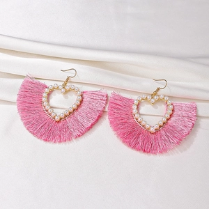 Pink fan-shaped tassel earrings with hollow heart design and pearl trim on satin