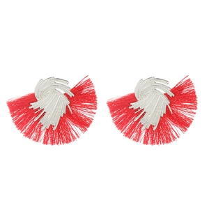 Detailed shot of red silk tassel earrings with silver textured fan-shaped metal studs