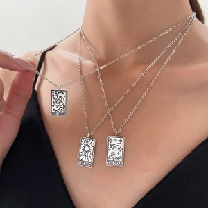 Detailed view of vintage silver tarot card necklace set featuring Moon, Sun, and Star pendants.