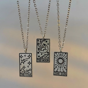 Vintage tarot card necklace set featuring sun moon and star pendants in silver finish