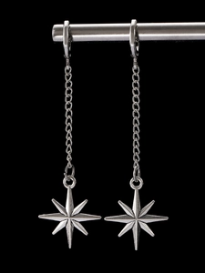 Macro detail of gothic silver star pendant earring with long chain and matte finish