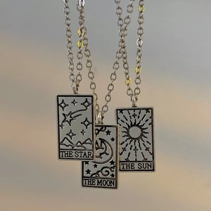 Detailed view of silver tarot card necklaces featuring Sun Moon and Star pendants