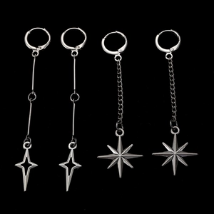 Detailed view of silver gothic star drop earrings with hollow and spiked star charms