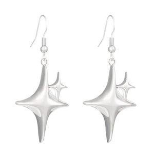 Macro shot of silver gothic star drop earrings with polished metallic finish on white back
