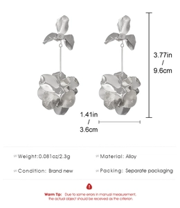 Detailed view of silver flower tassel earrings with dual 3D petals and long metal rod