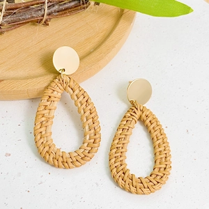 Bohemian style woven teardrop earrings with gold circular studs for beach vacation look