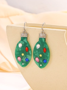 Detailed view of green Christmas bulb earrings with colorful inlaid gems on display stand