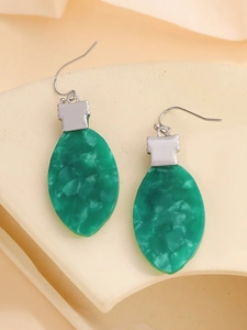 Macro view of green marble texture resin earrings with silver hooks for Christmas
