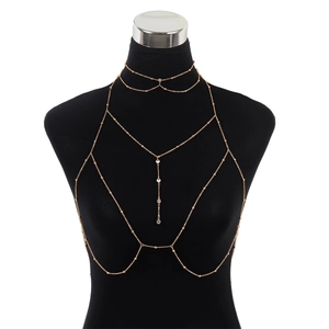 Multilayer rose gold body chain with crystal pendants on a black mannequin display