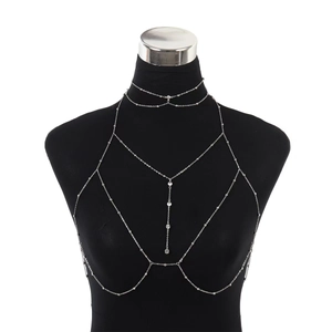Silver body chain with layered rhinestone tassels on a black mannequin display