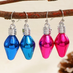 Christmas light bulb earrings in blue and rose red hanging on a natural branch