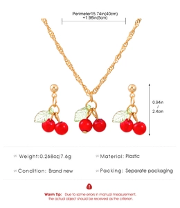 Detailed view of cherry pendant necklace and earrings with precise product dimensions