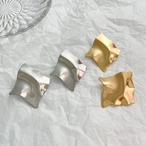 Modern gold and silver irregular geometric wave earrings with glossy mirror finish