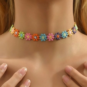 Detailed view of colorful floral embroidery choker on model for a bohemian look