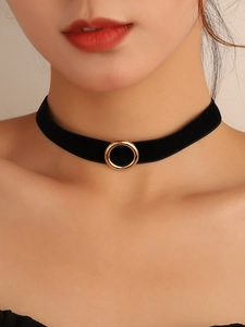 Gothic black velvet choker necklace featuring a minimalist gold metal ring pendant on a model