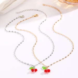 Detail of cherry necklaces in gold and silver finish with adjustable lobster clasps