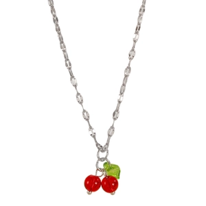 Close-up of translucent cherry pendant necklace with silver chain and green leaf detail
