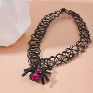 Gothic black elastic tattoo choker with a spider pendant featuring magenta gemstones