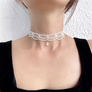 White lace choker necklace with gold-rimmed teardrop pearl pendant on a model