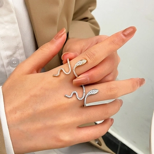 Detailed view of snake rings with micro-set zircon stones in gold and silver finishes