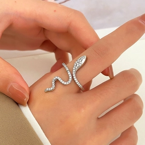 Detail shot of micro-pave cubic zirconia silver snake ring worn on index finger