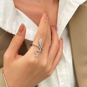 Silver snake ring with white cubic zirconia worn by a model on index finger