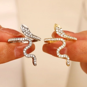 Detail of snake rings in gold and silver finish featuring micro-pave cubic zirconia
