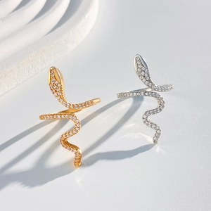 Detailed view of entwined snake rings with micro-pave zircons in gold and silver finish