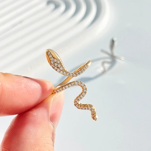 Macro shot of gold snake ring featuring micro-pave cubic zirconia and adjustable band