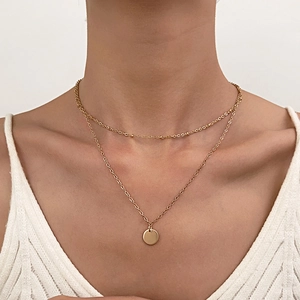 Double-layered gold necklace with minimalist round pendant and vintage dainty chain style