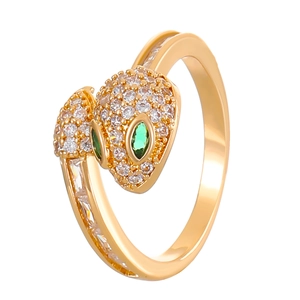 Macro shot of gold-plated snake ring with micro-paved white and green zircons