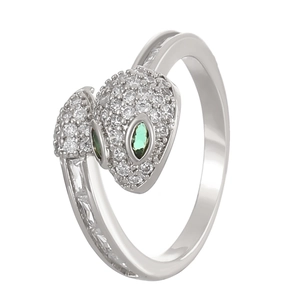 Macro shot of silver snake ring featuring zircon pave setting and green emerald eyes