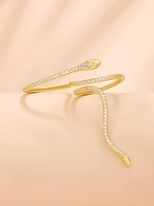 Detailed close-up of gold-plated snake ring with micro-set cubic zirconia stones