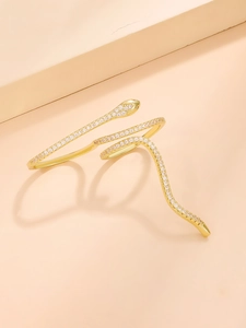 Macro shot of gold-plated snake ring featuring micro-pave white cubic zirconia stones