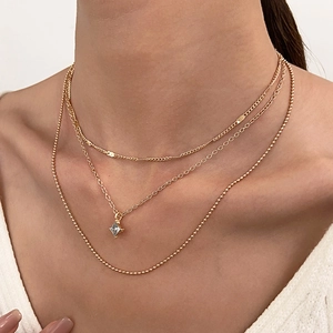 Three-layer gold necklace set featuring flat snake chain and square zircon pendant charm